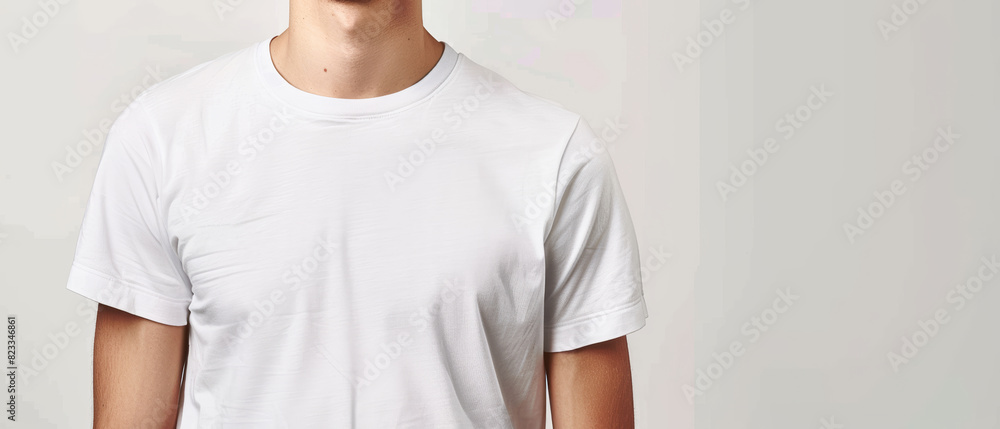 A man in a plain white t-shirt stands against a light background, ideal for branding mockups. A man in a plain white t-shirt stands against a light background, ideal for branding mockups.