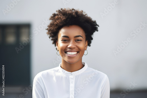 Portrait of a happy smiling modern girl of African American ethnicity with curly hair