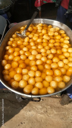 Most famous sweet Roshogollah making and kerping it within juic filled drum. photo