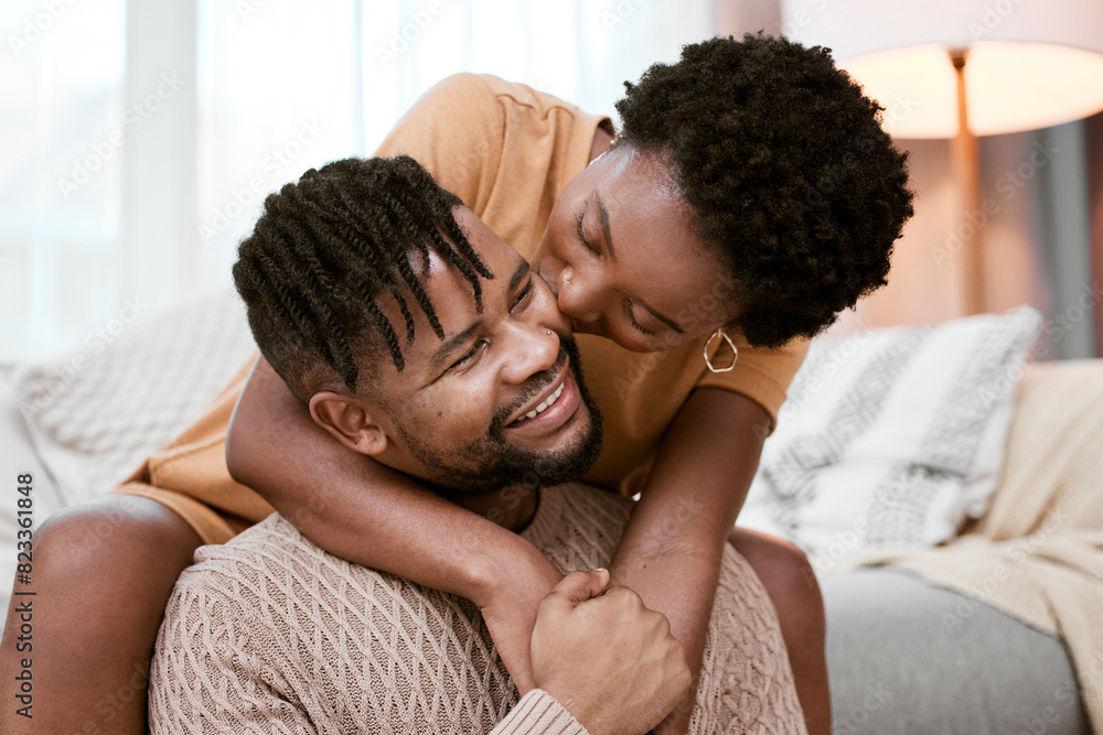 Couple, black woman and man in living room, kiss and hug for love, smile and romance in home to relax. House, African person and partner in lounge, embrace and happy for marriage and commitment Couple, black woman and man in living room, kiss and hug for love, smile and romance in home to relax. House, African person and partner in lounge, embrace and happy for marriage and commitment