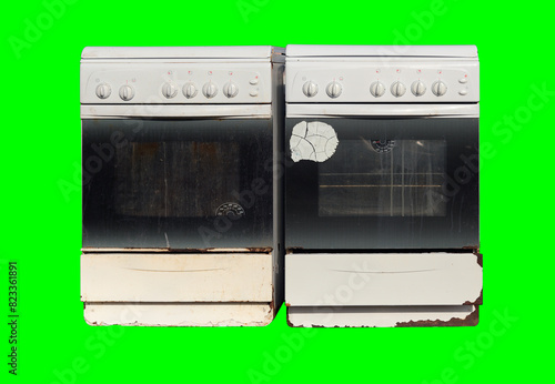 Old gas stoves isolated on green background. Recycling of household appliances.