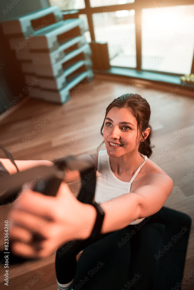 Beautiful woman doing exercise with trx system.Fitness exercises with loops.Concept workout healthy lifestyle sport. Beautiful woman doing exercise with trx system.Fitness exercises with loops.Concept workout healthy lifestyle sport.