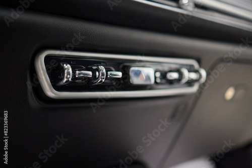 Detailed view of luxury vehicle dashboard with shifter and buttons