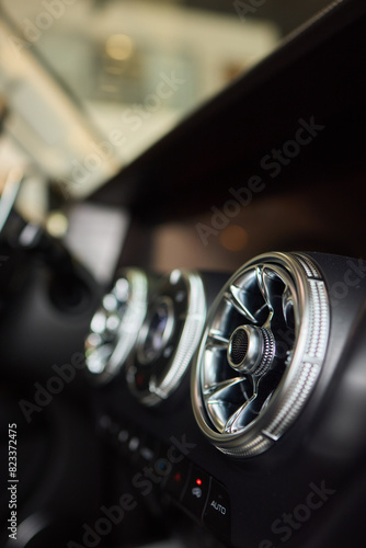 Closeup of car dashboard air vents near gear shift © Евгений Вершинин
