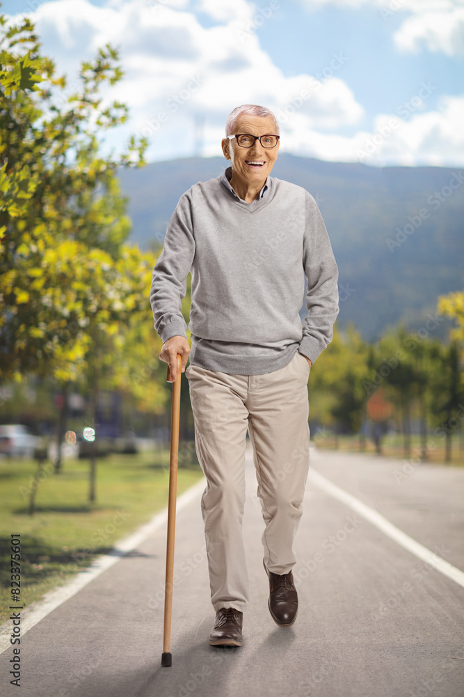 Elderly man with a cane smiling and walking Elderly man with a cane smiling and walking