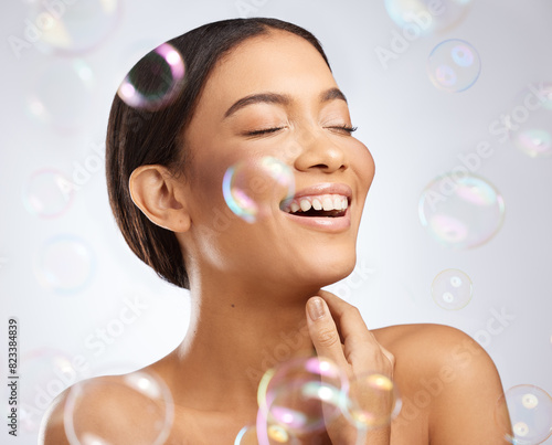Studio, bubbles and beauty for calm woman, clean and grooming on white background. Cosmetology, smile and confidence for relax female model, dermatology and salon treatment for skincare or wellness