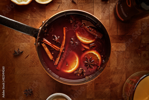 Top view of a pot of mulled wine on a rustic wooden table