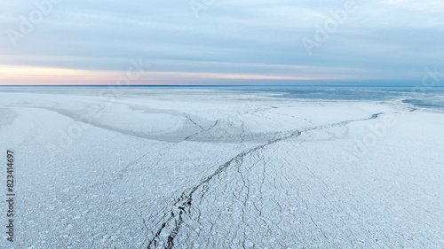 Картината върху платно Sunset colored panoramic view of the calm seabay with the edge of the cracked se