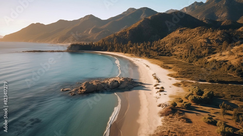 Drone view of beautiful beach with sand and rock surrounded by mountains in the sunny day. Aerial Landscape concept.