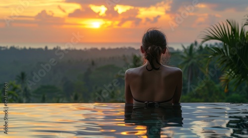 Woman Enjoying Colorful Sunset from Bali Hotel Rooftop  