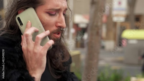 Transgender drag queen man on a phone call while walking the street. Gay LGBT people
