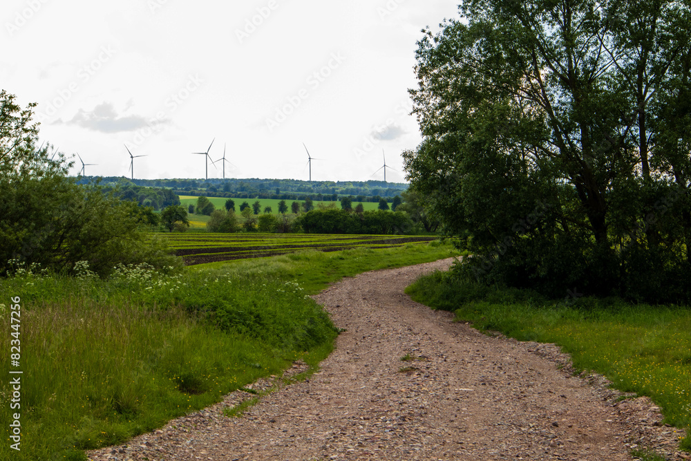 Landscape with winding rural road and with wind generators Landscape with winding rural road and with wind generators