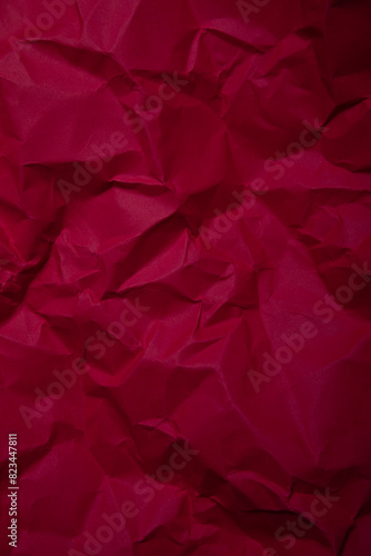 Piece of red wrinkled paper texture background  photo