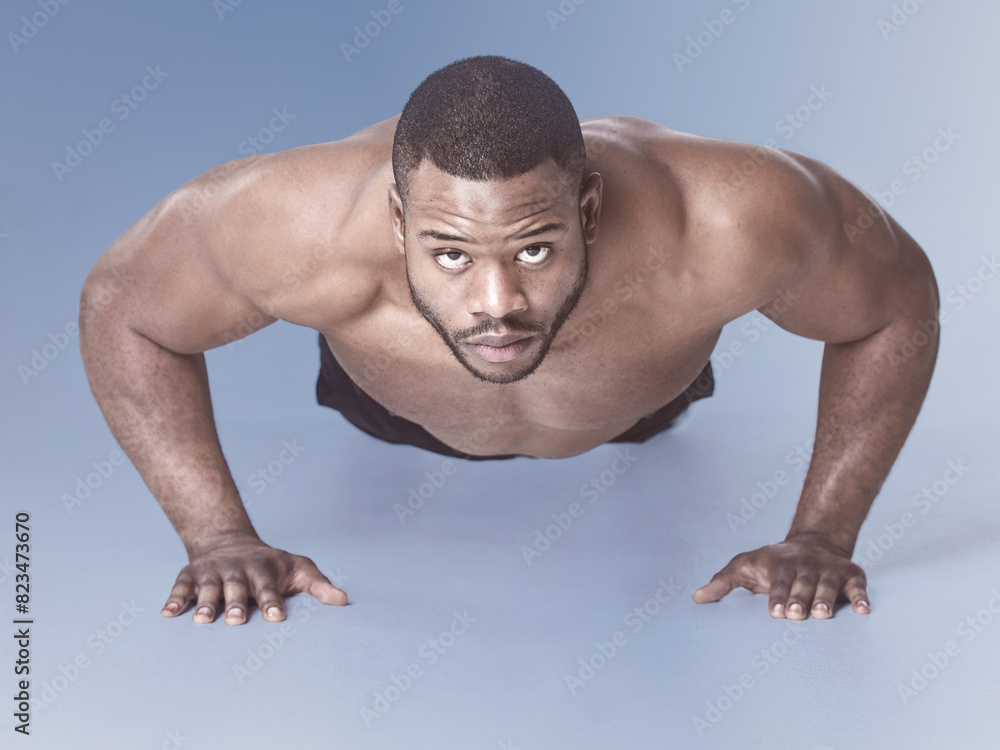 Man, push up and fitness portrait with strong exercise, wellness and training with strength and arm health. Studio, athlete and muscle with gym practice and blue background with workout and sport Man, push up and fitness portrait with strong exercise, wellness and training with strength and arm health. Studio, athlete and muscle with gym practice and blue background with workout and sport