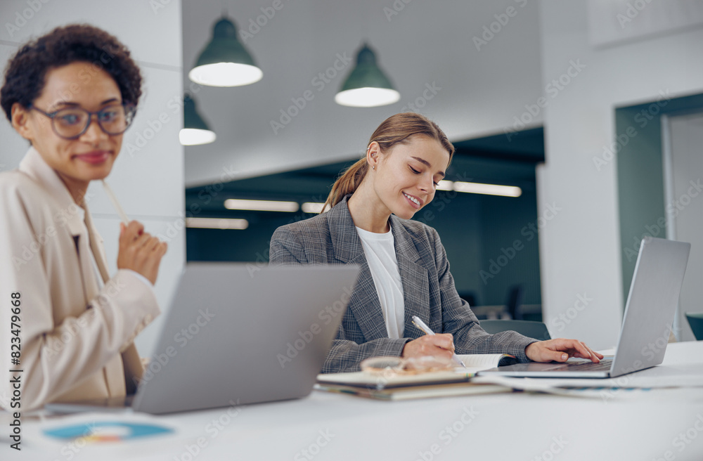 Focused successful female business people working together in a coworking office Focused successful female business people working together in a coworking office