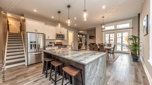 Sleek and modern kitchen with stainless steel appliances  marble countertops  and an island with bar stools