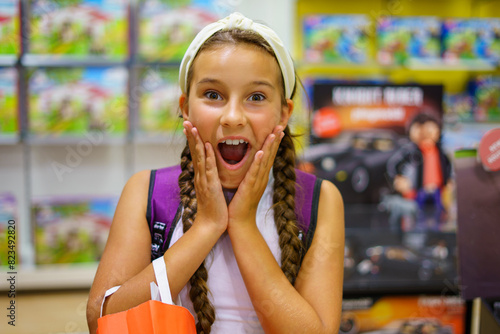 Cute girl surprised in a toy store