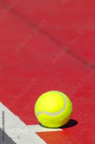 ball on a red hard surface tennis court