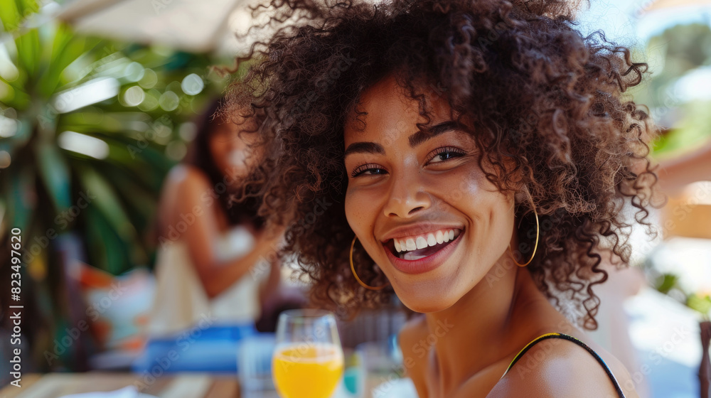 A woman with a cheerful smile holding a glass of freshly squeezed orange juice A woman with a cheerful smile holding a glass of freshly squeezed orange juice