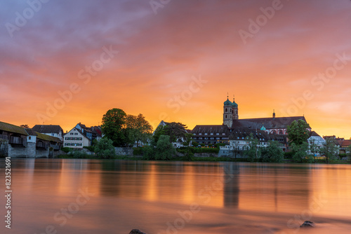 sunset over the skyline of bad säckingen germany at the river rhine with the historic saint fridolin church photo