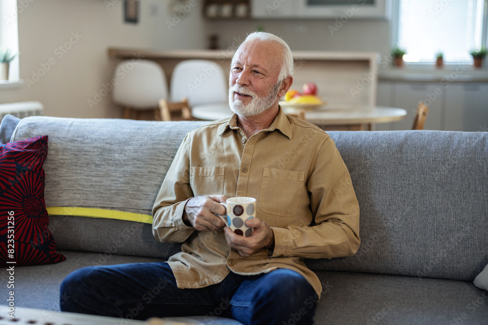 Elderly man, sofa and tea to relax with drink for peace, quiet and me time to start morning in house. Senior men, couch and tea for happiness, thinking and memory from aroma in home living room. Elderly man, sofa and tea to relax with drink for peace, quiet and me time to start morning in house. Senior men, couch and tea for happiness, thinking and memory from aroma in home living room.