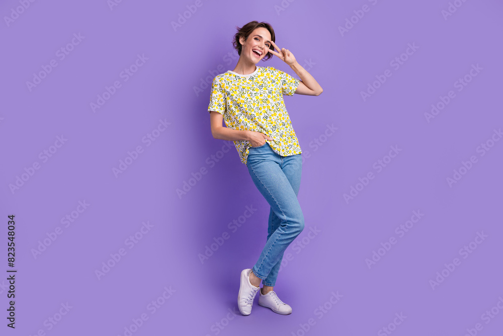Full size photo of pretty young woman show v-sign eye wear t-shirt isolated on violet color background Full size photo of pretty young woman show v-sign eye wear t-shirt isolated on violet color background