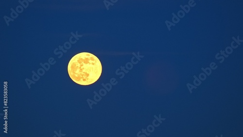 Golden Full Rising Moon Shining Bright on Evening Sky