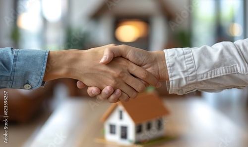 Close up hands of residential house businessman banker shake hand with customer after successful agreement