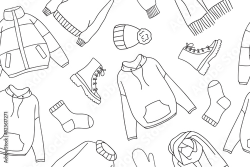 Warm autumn and winter clothes seamless pattern in doodle style. Vector collection of warm, cozy clothes and shoes. Seasonal clothing seamless pattern. Vector