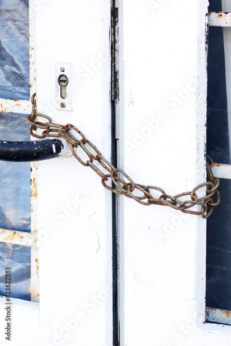a white door with a chain attached to it