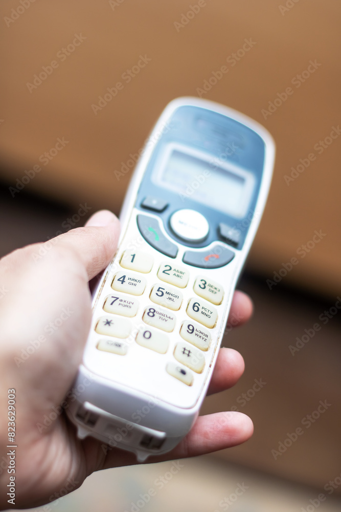 Person holding a communication device with the number 1 displayed on the screen Person holding a communication device with the number 1 displayed on the screen