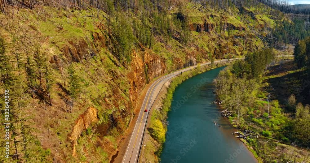 Bare rocks and narrow river at the foot. Sunny view of the mountains in Oregon State, the USA. Bare rocks and narrow river at the foot. Sunny view of the mountains in Oregon State, the USA.
