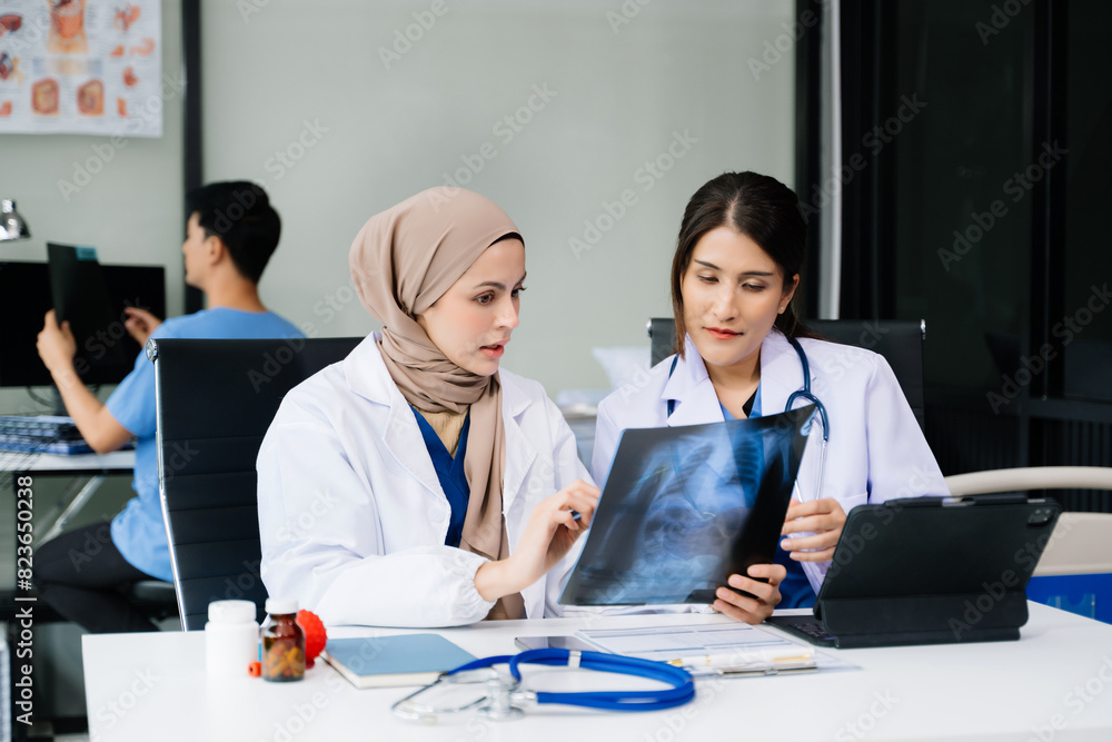 Doctors analyzing results or diagnosis of patient in clinic. Teamwork, medical and healthcare workers in discussion and research on desk in hospital Doctors analyzing results or diagnosis of patient in clinic. Teamwork, medical and healthcare workers in discussion and research on desk in hospital