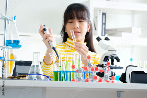 Girl doing science experiment science classroom.