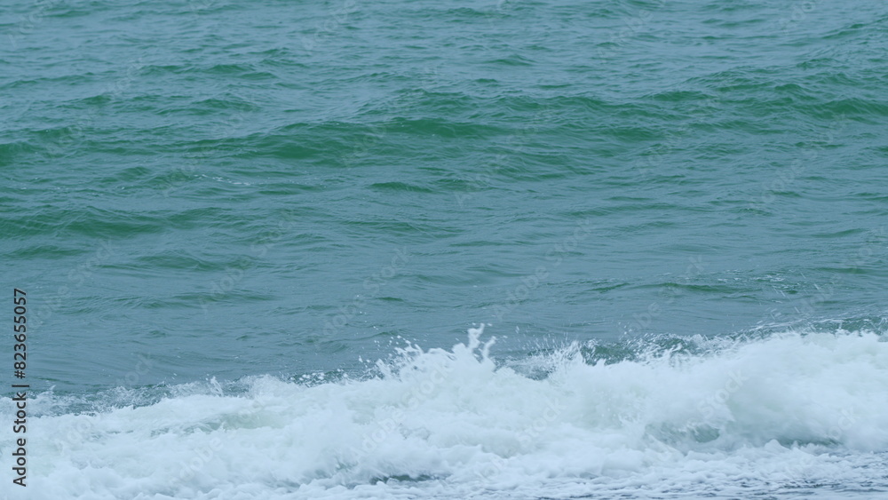 Waves With Seafoam Breaking On Beach. Ocean Great Blue Wave Sea. Slow motion.