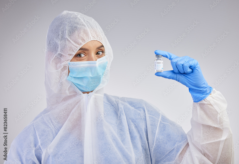 Portrait, vial and nurse in ppe with mask on for safety and medical practice in white studio background. Danger, healthcare worker or female person in scrubs for viral defence and protection Portrait, vial and nurse in ppe with mask on for safety and medical practice in white studio background. Danger, healthcare worker or female person in scrubs for viral defence and protection