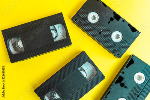 Video cassette tape on a yellow background. Retro videotape with movie.