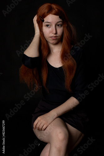 portrait photographs of a beautiful redhead woman on black background