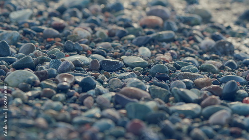 Multi-Colored Round Sea Pebble On Sea Coast. Wave Leaves White Marks.