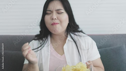 chubby woman eating potato chips