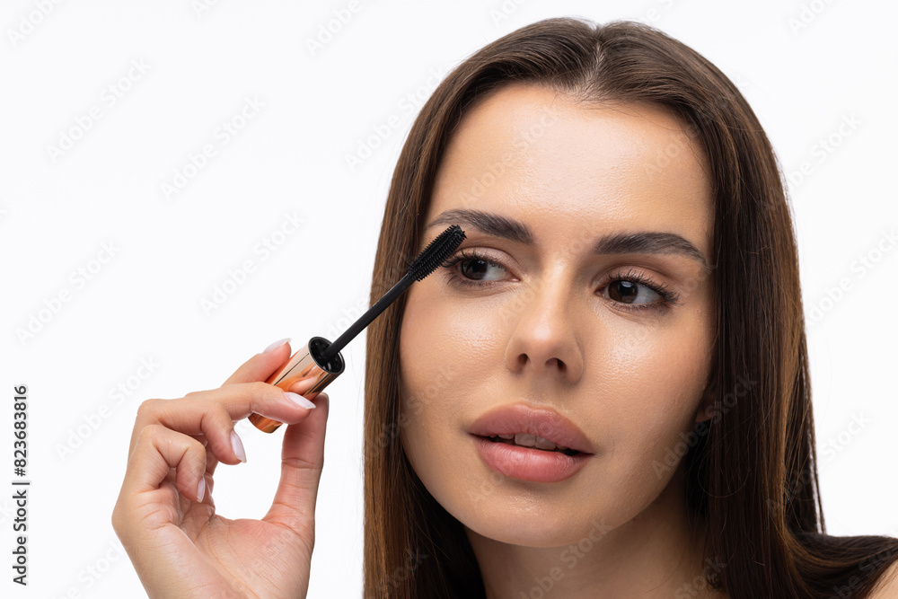 Mascara Applying. Long Lashes closeup. Mascara Brush on white background Mascara Applying. Long Lashes closeup. Mascara Brush on white background