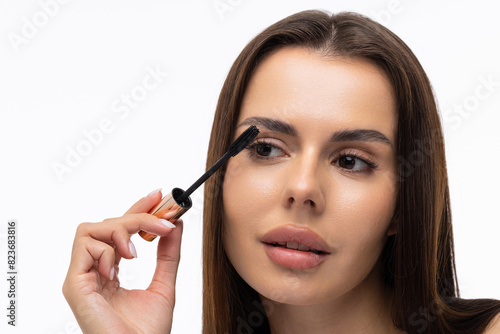 Mascara Applying. Long Lashes closeup. Mascara Brush on white background