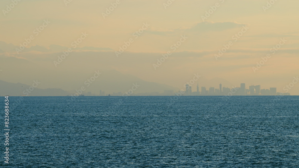 City Skyline At Golden Sunset In Evening. Modern Futuristic City Located On The Surface Of The Sea. Still.