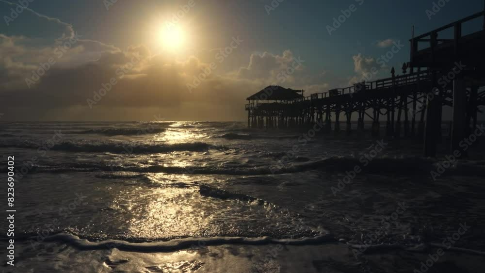 longing view of Cocoa beach pier in Florida. Sunrise on the ocean. longing view of Cocoa beach pier in Florida. Sunrise on the ocean.