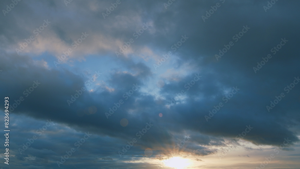 Intense dramatic panoramic sunset. Abstract different shades clouds at sunset sky background.