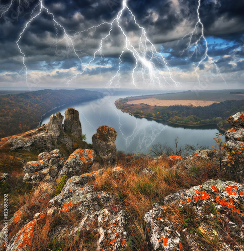 Peaceful view of the canyon Dnister river in a storm. Dramatic landscape with thunderstorm. Powerful lightning over the river. Nature of Ukraine photo