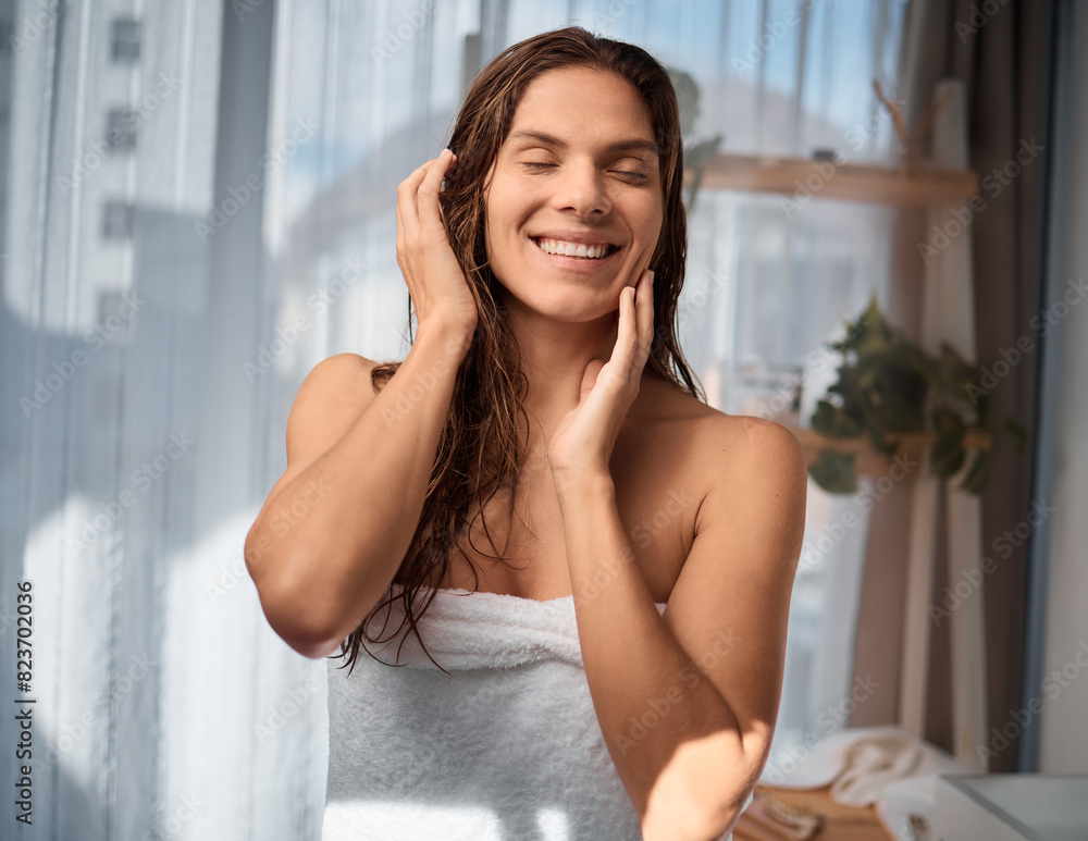 Woman, towel and haircare with smile for beauty, skin care and treatment in bathroom of house. Happiness, shower and wellness and shampoo for female person, cleaning or conditioner at home in morning