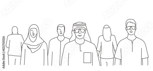 A group of people are walking down a street