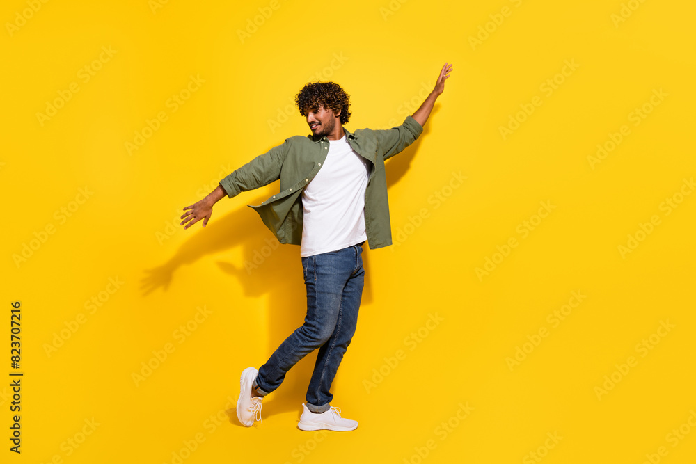 Fototapeta premium Portrait photo of young funny mexican guy have some fun chill out clubbing in khaki shirt isolated on yellow color background