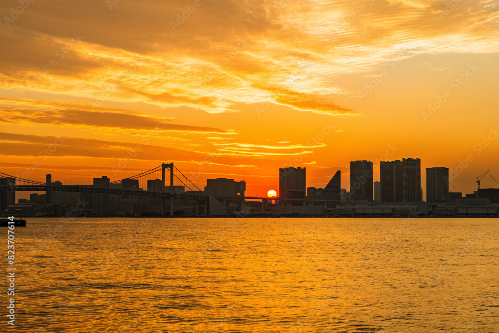 beautiful sultry sunset landscape with silhouette of famous Rainbow Bridge Tokyo, Japan, travel background